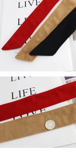 Detailed macro view showing suede fabric texture and fine stitching on the coat belt