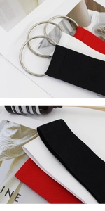 Detailed macro view of elastic fabric belts in red, white and black with silver metal rings