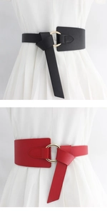 Detalle de cinturones anchos de moda con hebillas redondas doradas en negro y rojo en vestido