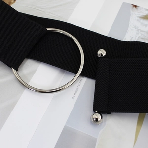 Black elastic waist belt with large silver round metal buckle and decorative sphere studs