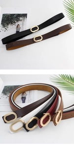 Detail showing various colors of slim belts with oval golden buckles and fine leather texture