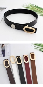 Close-up of matte leather belts with polished gold oval buckles in multiple colors