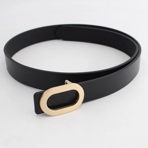 Minimalist black matte belt with a golden oval metal buckle for jeans and work trousers