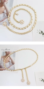 Close-up of golden metal waist chain with white leather weave and camellia flower charms