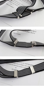 Detail of adjustable black and white striped elastic belt with silver metal buckle
