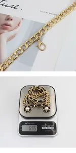 Detail of gold metal chain woven with black leather featuring camellia pearl charms