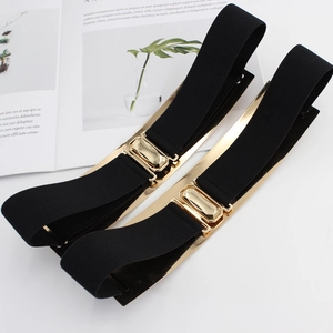 Chic gold mirror plate elastic waist belts for dresses shown in a lifestyle flat lay