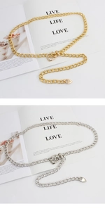 Detailed view of hollow chunky metal chain belts with heart charms in gold and silver