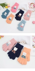 Detailed view of colorful knitted kids gloves with cute white cat patch decor