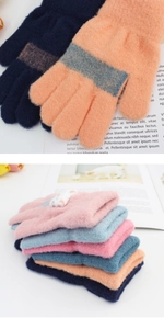 Detail of warm knitted gloves with thick plush texture, colorful stripes, and cute cat patches
