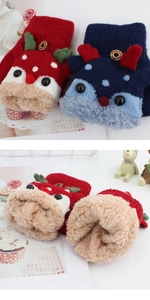 Detail of warm knitted kids gloves with reindeer design and thick fleece lining texture