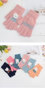 Detail of children's knitted gloves featuring 3D cartoon cat patches and elastic ribbed cuffs