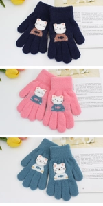 Detailed view of knitted kids gloves with cute white cat patches in three colors