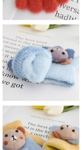 Detail showing soft plush texture and cute cartoon bear embroidery on kids winter gloves