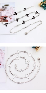 Close-up of bow knot metal waist chain with black and white butterfly charms and rose pendant