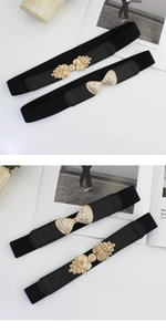 Detail of black elastic belts for women with rhinestone bow and golden swirl buckles