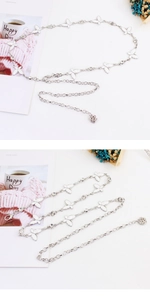 Detailed view of silver bow metal waist chain with rhinestones and flower pendant