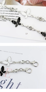 Detailed macro view of the silver metal lobster clasp and sparkling bow chain connectors
