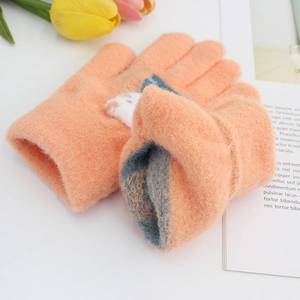 Cozy orange knitted gloves for kids with white animal patch and warm blue lining
