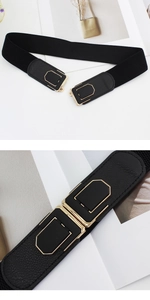 Detail view of black elastic waist belt featuring a geometric gold-trimmed metal buckle