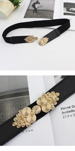 Close-up of women's vintage elastic waist belt with ornate golden alloy buckle and black leather