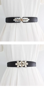 Detail of leaf and flower rhinestone buckles on black elastic waist belts for dresses