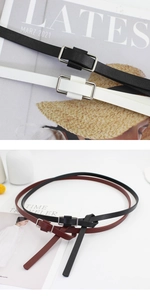 Detailed macro view of minimalist leather belts with sleek silver square metal buckles