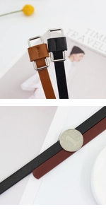 Detail of slim black and brown leather belts with rectangular silver metal buckles