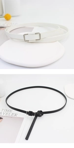 Detail showing high-quality black and white slim faux leather belts with silver buckle