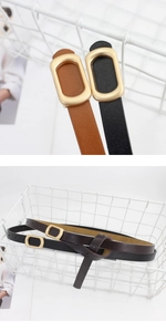 Close-up of gold rectangular metal buckle on slim leather belts for women in diverse colors