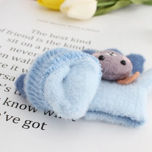 Light blue knit baby mittens with plush lining and cute purple cartoon bear detail