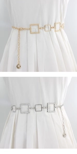 Detailed view of square link metal waist chain in polished gold and silver finishes