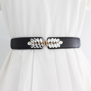 Elastic black waist belt for women with golden flower rhinestone buckle on white dress