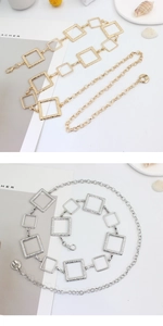 Detail of square link metal waist chains in gold and silver finish with lobster clasp
