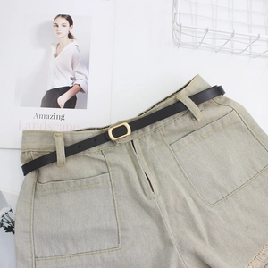 Denim shorts with raw hem and black leather belt featuring a golden square buckle
