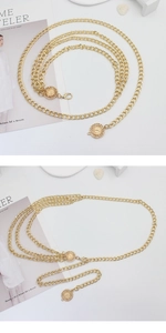 Detail of adjustable gold layered waist chain with sun relief medallions and lobster clasp