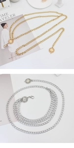Detail of adjustable metal waist chains with decorative sunflower charms in gold and silver