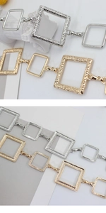 Detailed close-up showing square metal waist chain links with textured and smooth finishes