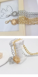 Close-up of adjustable multilayer metal waist chains with bohemian sun flower pendants