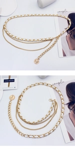 Detail of layered gold metal waist chain with white PU leather strap and coin pendant