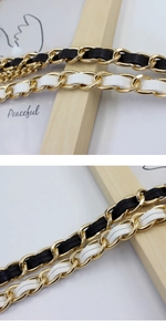 Detail of woven PU leather and gold metal chain strap for dresses and sweaters
