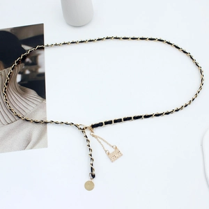 Elegant gold metal waist chain with black leather weaving and mini quilted bag pendant