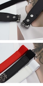 Detail of vintage rose buckle and screws on elastic waist belts in black, red, and white