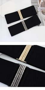 Close-up of wide elastic waist belts with gold and gunmetal industrial metal buckles