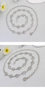 Macro view of silver hollow leaf metal belt with flower pendant and lobster clasp