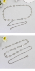 Detail of silver hollow leaf chain belt featuring an adjustable tail with flower pendant