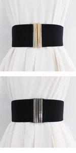 Detail of wide elastic waist belt with gold and gunmetal metallic textured buckles