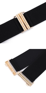 Detail view of elastic waist belt featuring golden interlocking metal buckle on black fabric