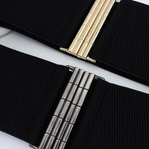 Elastic wide belt for women with elegant gold and silver metal buckles on a plaid texture