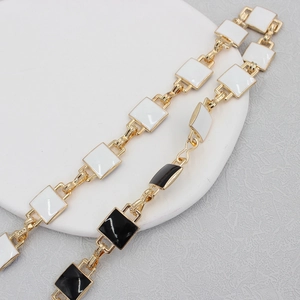 Elegant gold chain belt with black and white enamel squares for dresses and sweaters